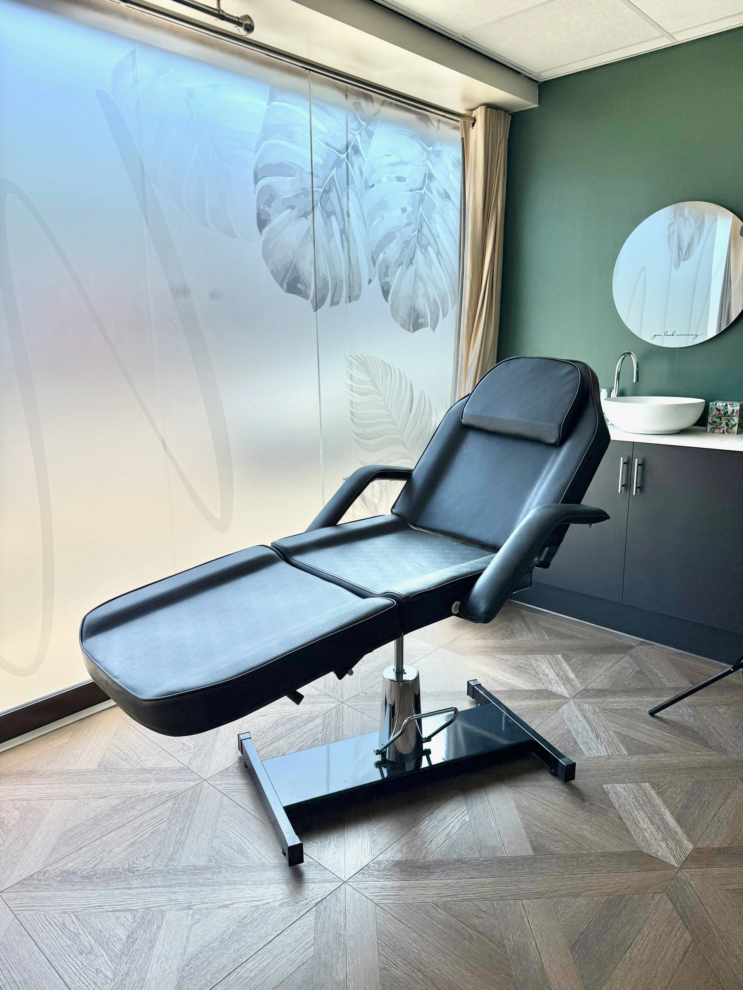 A styled treatment chair in a calm, softly lit room at The Wellness Lounge Leeds