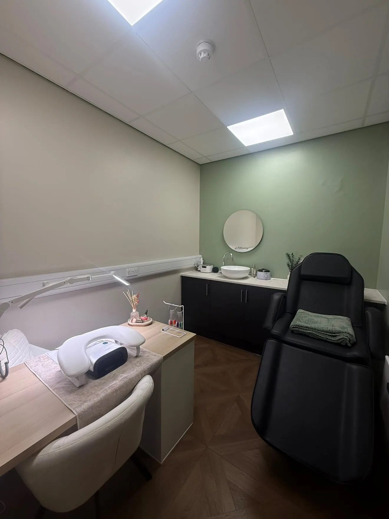 The Cedar Room at The Wellness Lounge Leeds set up for beauty treatments with a manicure desk and lamp